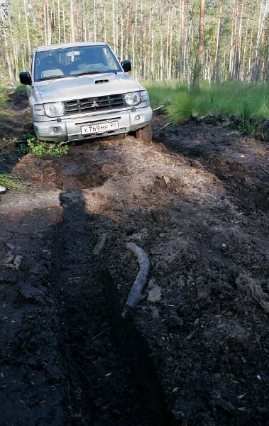 Not so tough road from the first glance (for 4x4) it became something when we discower that underground logs, 2 of them blocking front wheels and one - blocking rear ones. Slippery logs under soft slippery peat.